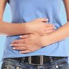 Beat the Digestive Disruptions Holding Tummy